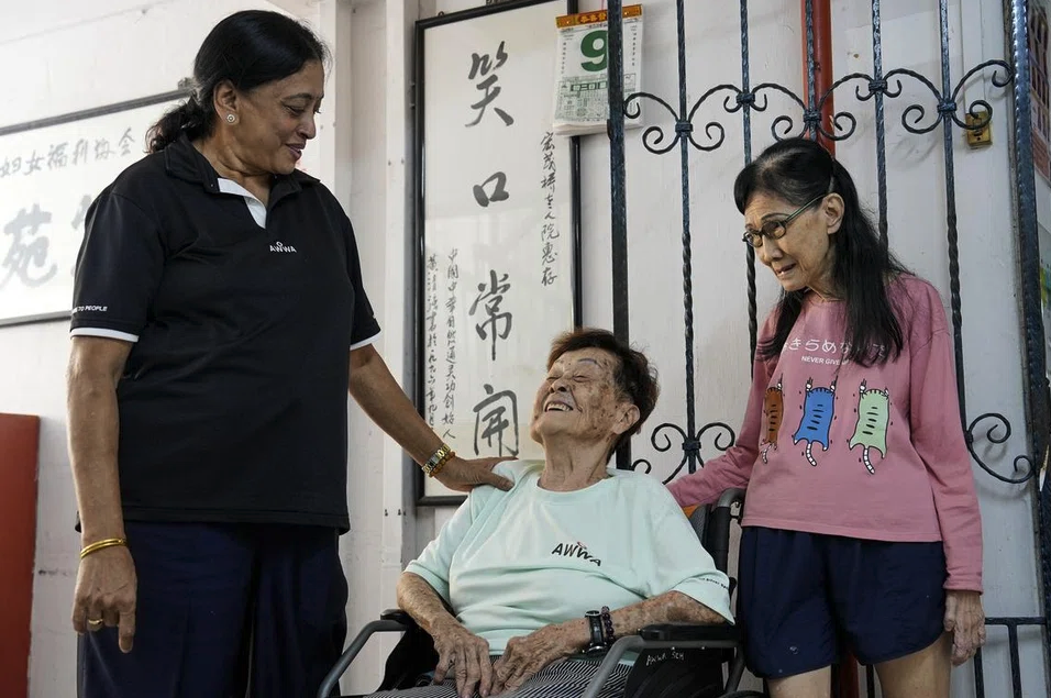 Mdm Vijaya Ponnusamy with the residents